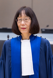 A judge wearing a black and blue toga