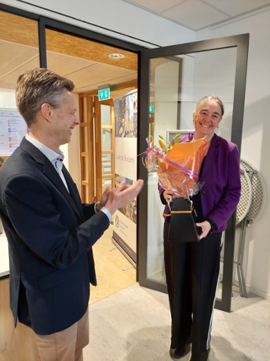 Francien Dechesne receives a bouquet of flowers from Bart Custers, Head of Department