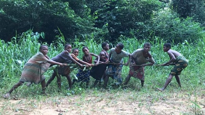 BaYaka women and children singing and having some fun while searching for tubers