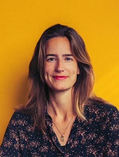 Portrait of Ellen Gijselaar with yellow background.